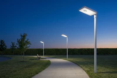 Illustration: solar LED walkway lights along a park path at dusk.