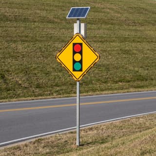 Illustration: a solar flashing signal ahead sign on a two-lane arterial cresting a rise.