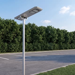 Illustration: a silver all-in-one solar LED lot light with two LED modules, switched off and charging, over a small parking lot in daylight.