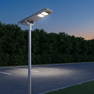 Illustration: a silver all-in-one solar LED lot light with two LED modules on a pole over a small parking lot at dusk.